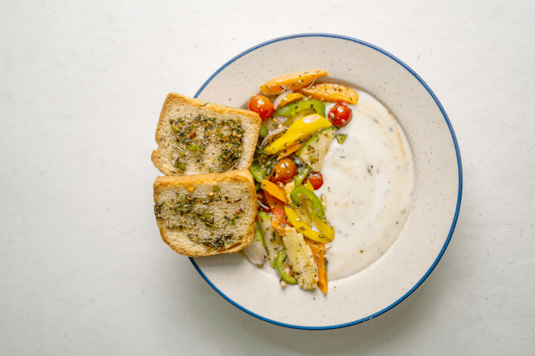 Exocitic Veg in creamy white Sauce with Paneer _ Tofu - With Herbed Rice _ Garlic Bread.png